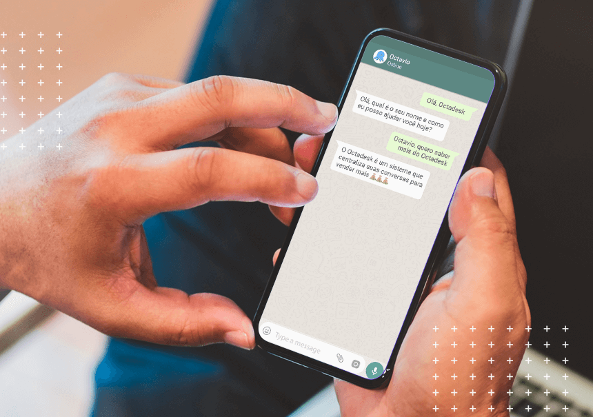 Mão segurando celular com tela aberta no WhatsApp da Octadesk
